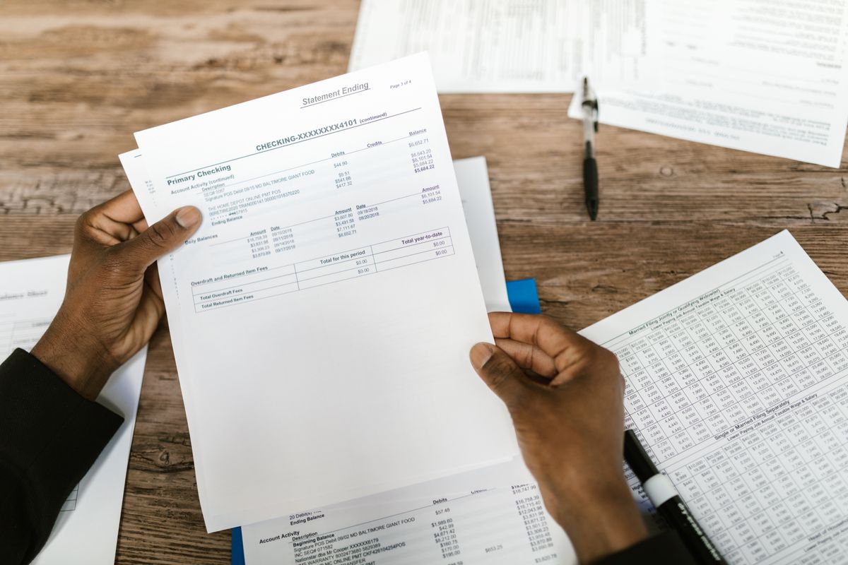 Filipino first-time homebuyer reviewing financial documents and loan computation at a desk