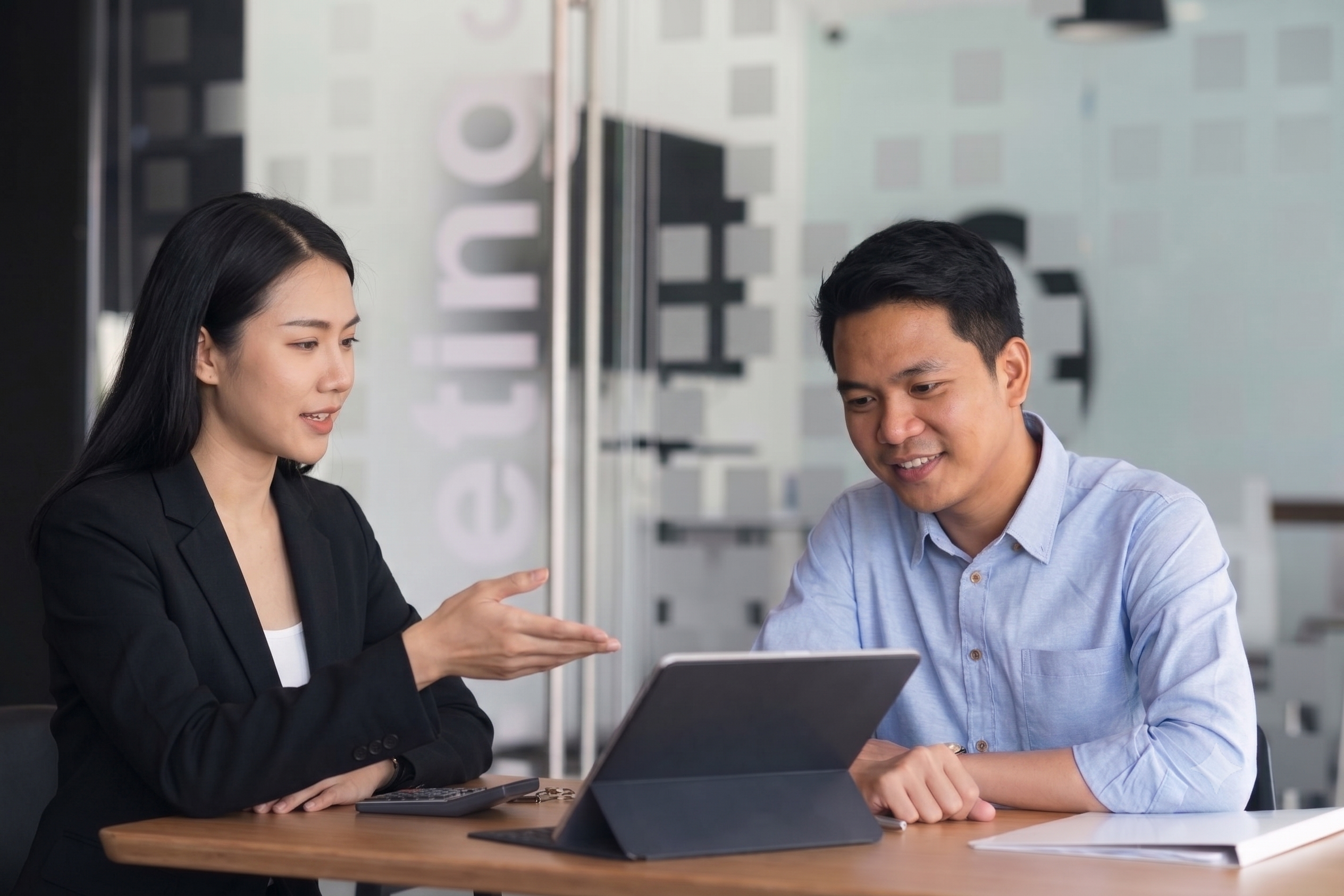 A first-time homebuyer looking at a condo building exterior in Cavite, considering financing options for their first property purchase in the Philippines