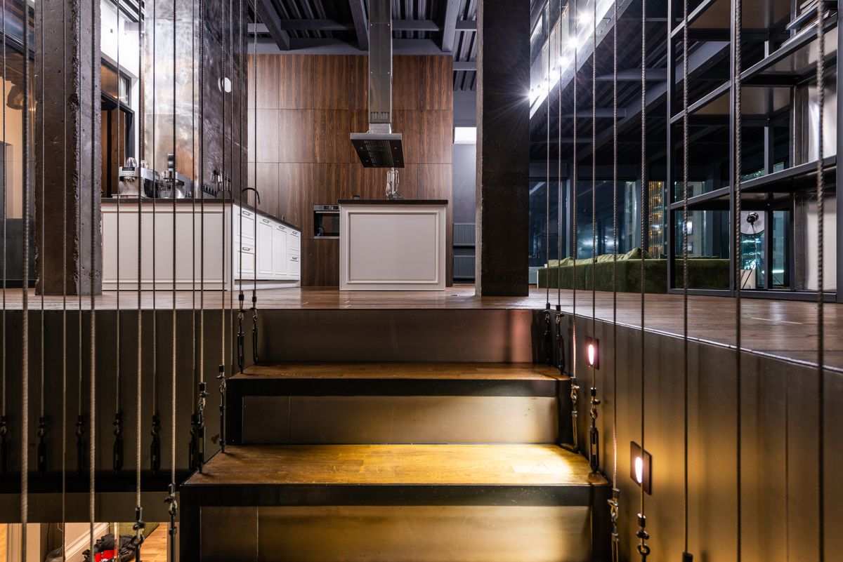 Loft-style condo interior with mezzanine level above an open living space, showing the extra usable floor area a loft layout adds