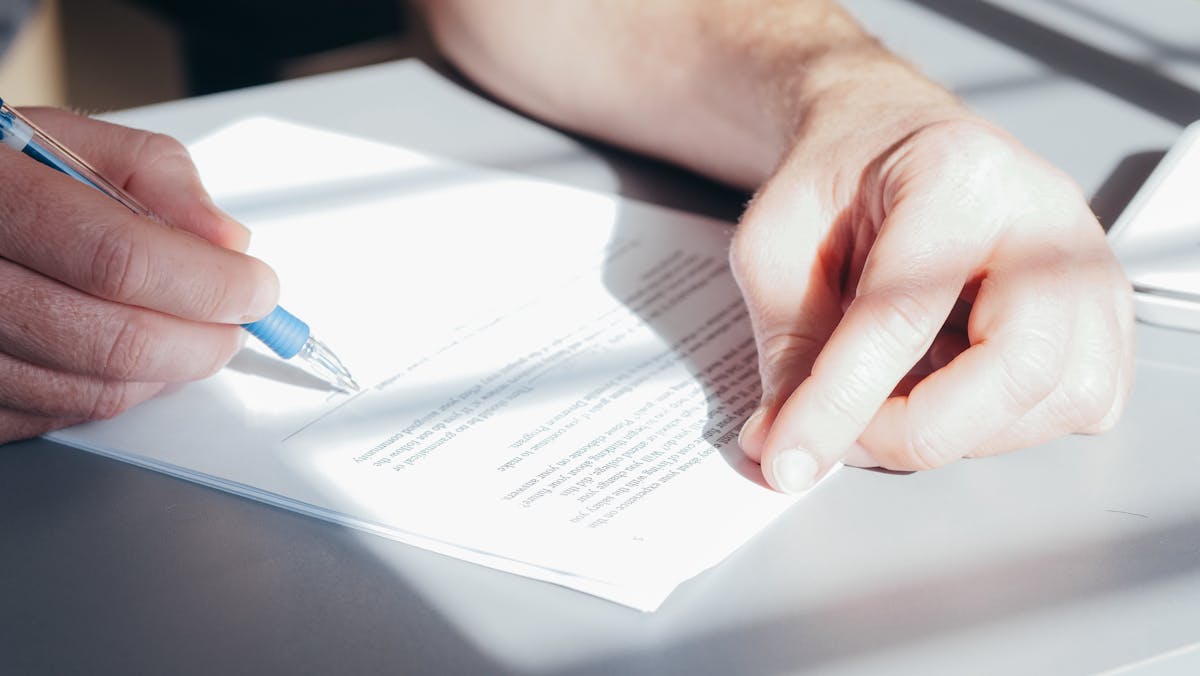 Signing a Pag-IBIG housing loan document in the Philippines — review all terms carefully before committing to a condo purchase