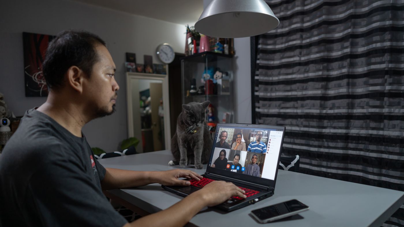 OFW video-calling family in the Philippines while reviewing condo ownership and remittance plans on a laptop